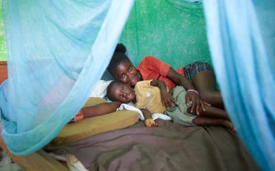 In Ghana, mother and son under an insecticide-treated bed net they received to protect them from mala